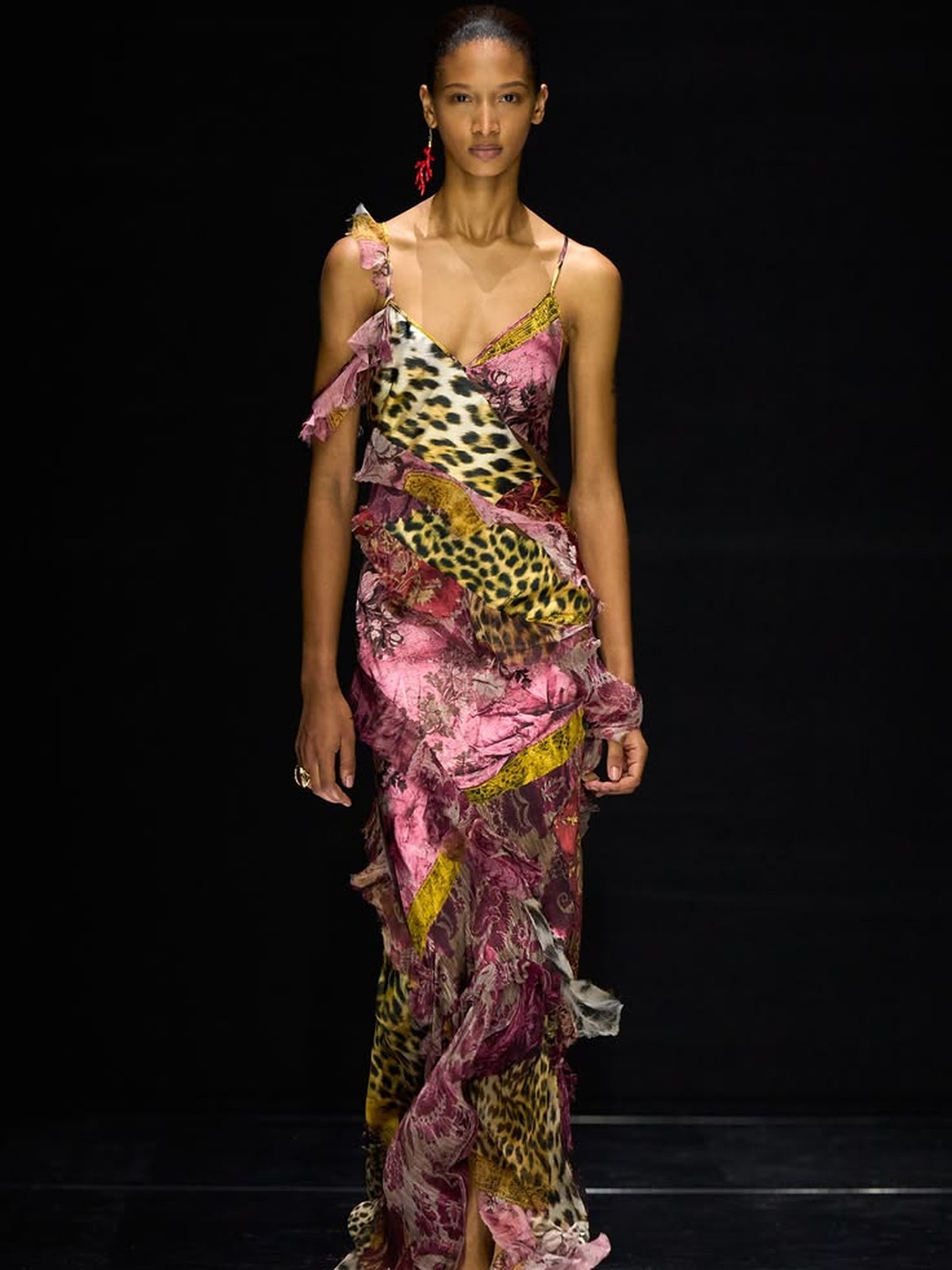 Runway model in a pink and gold animal print gown