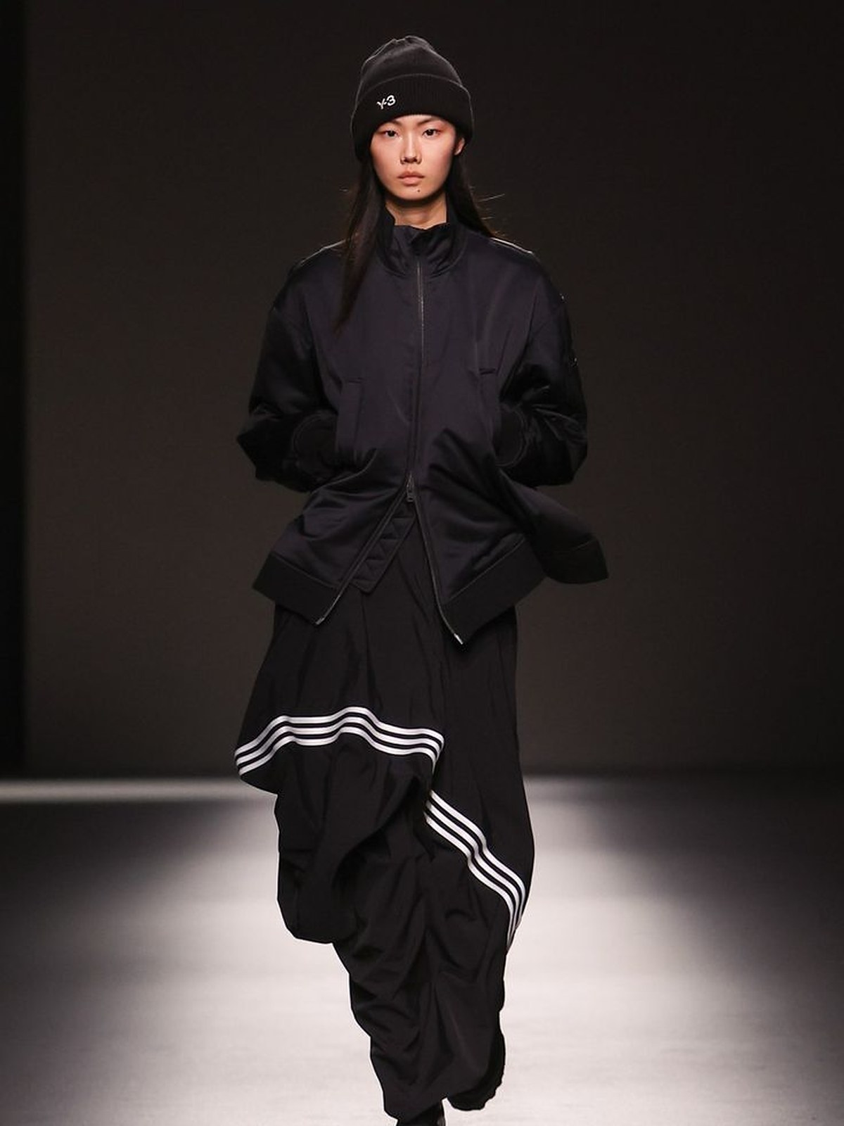 Y-3 runway model in a black bomber and wide trousers with white three stripes