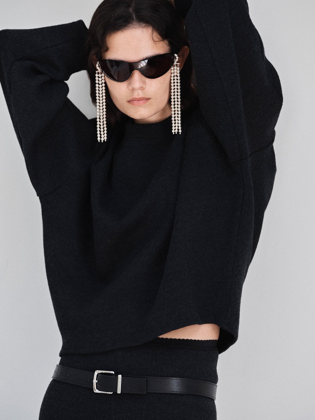 Model in black knit with long pearl earrings in the Beaufille FW26 lookbook