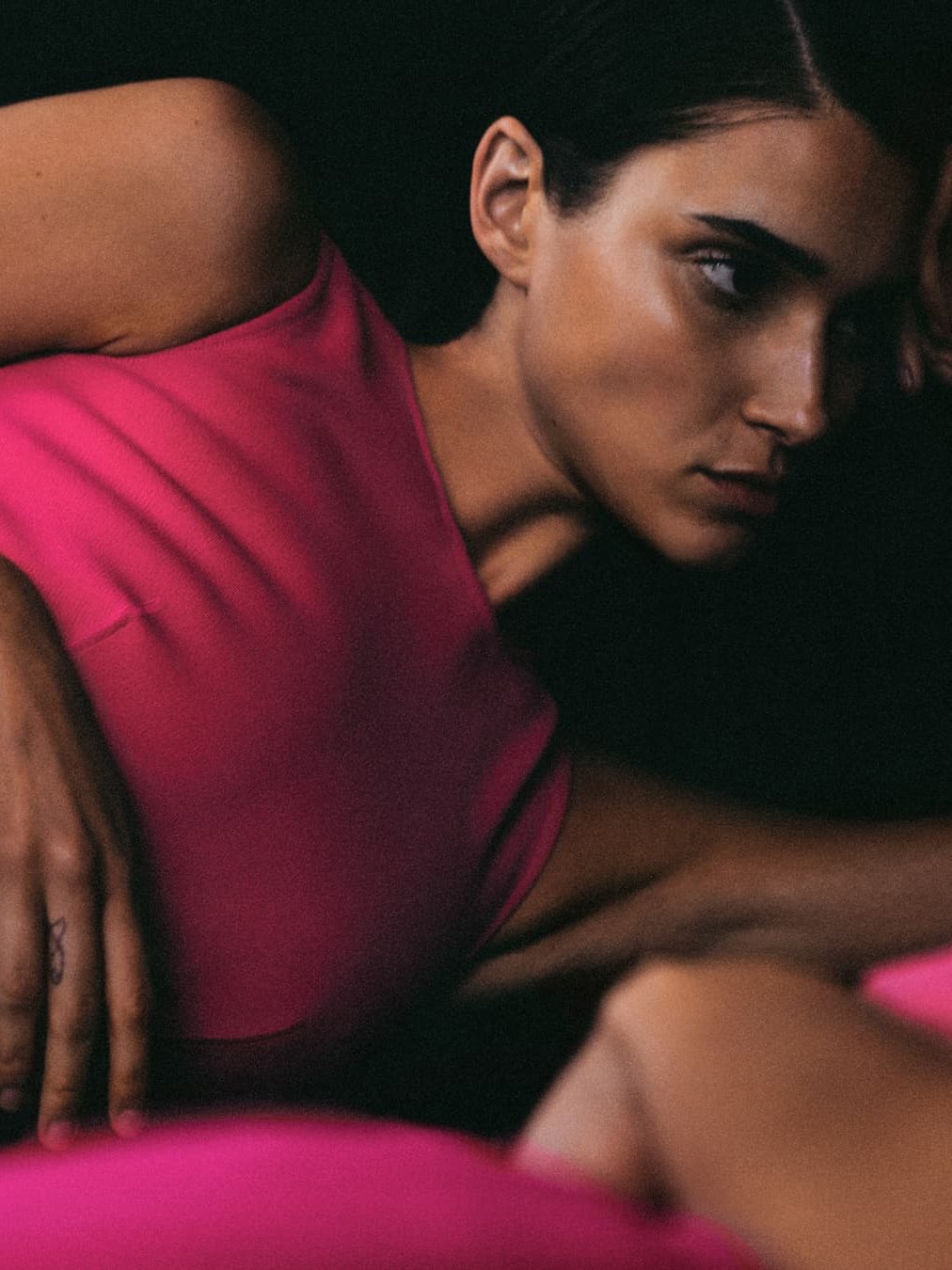 Model in a fuchsia knit dress in an intimate studio close-up
