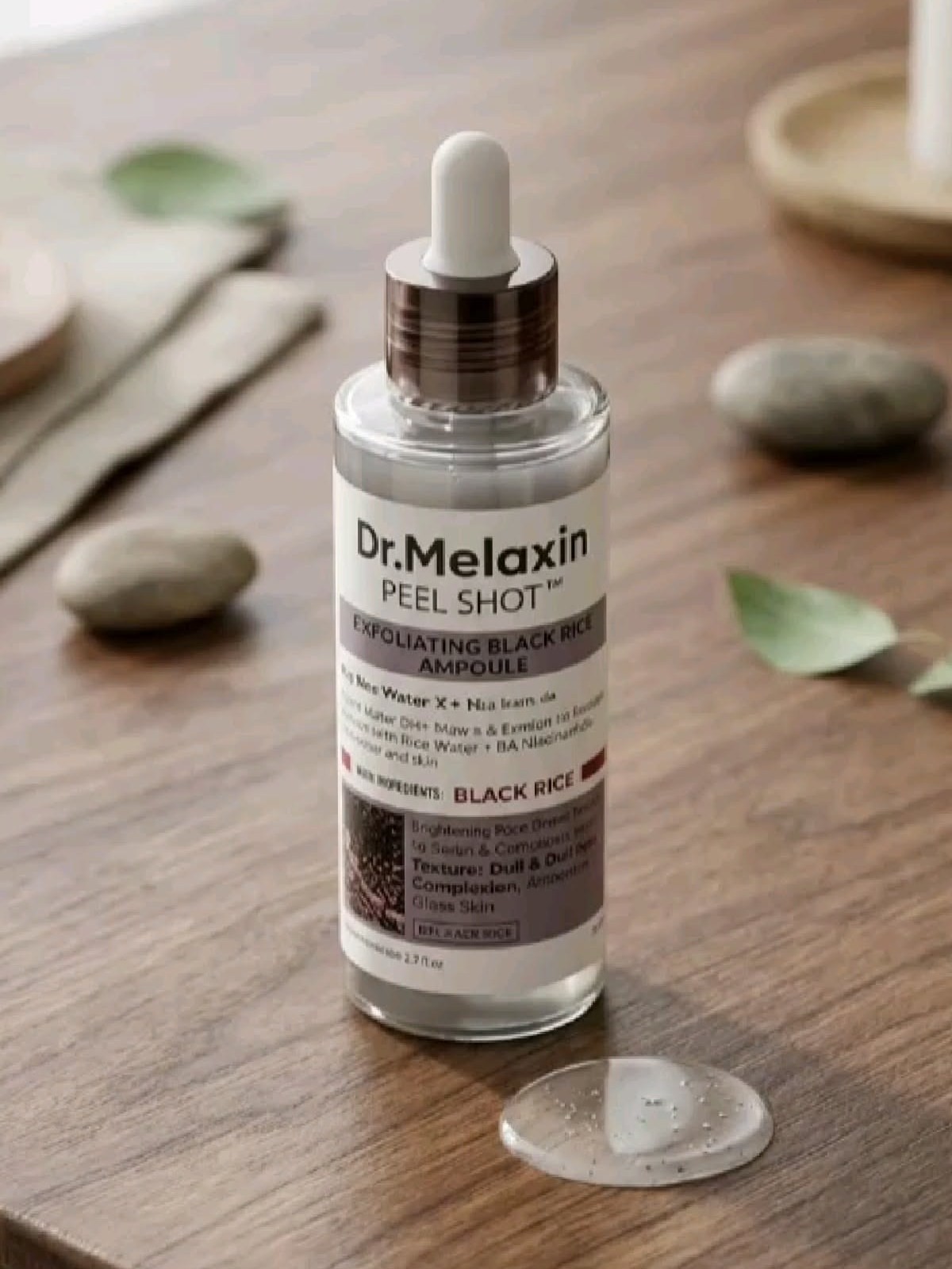 Dr. Melaxin Peel Shot Black Rice Ampoule bottle with a dropper swatch on wood