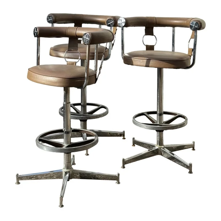 A striking set of 3 swivel bar stools by Daystrom furniture of Boston, featuring